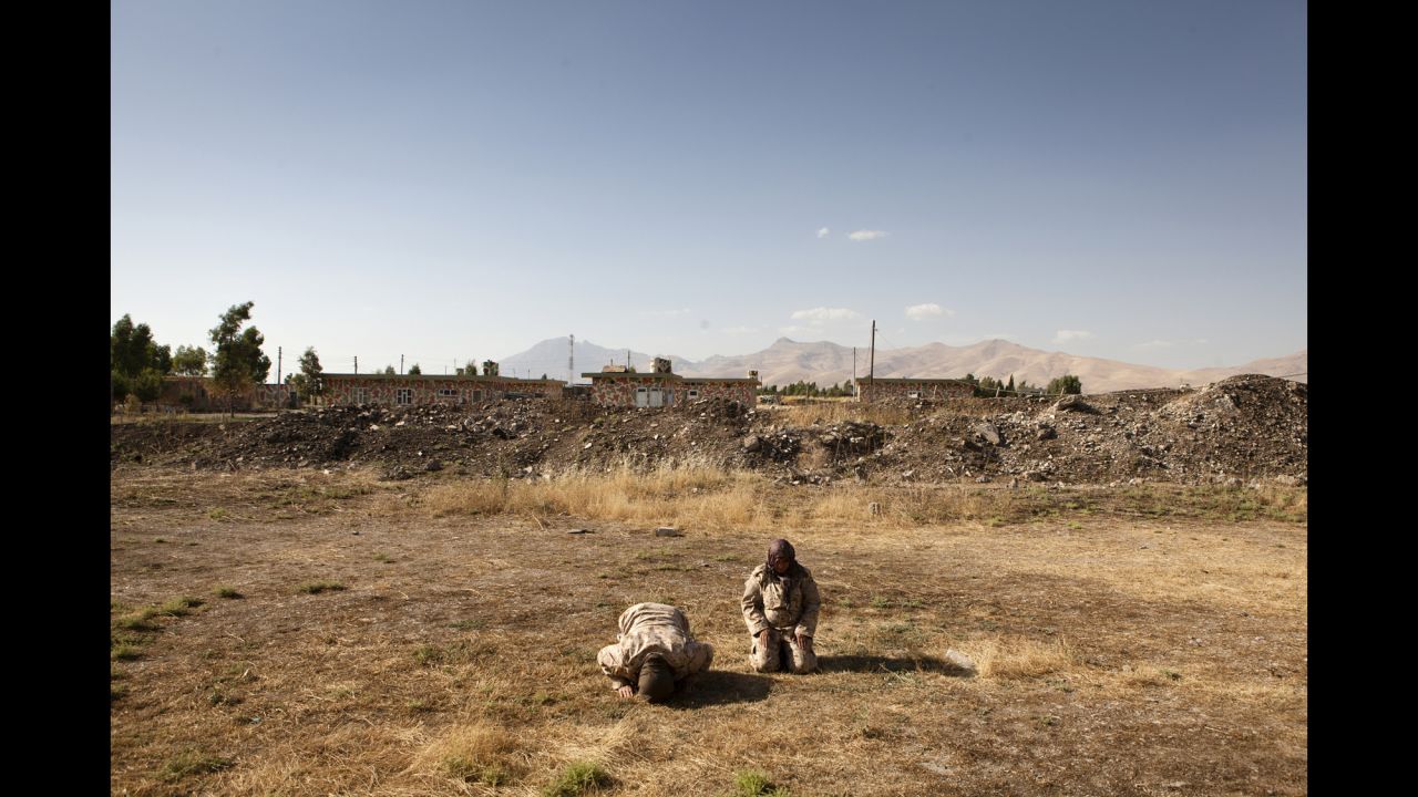 Two female Peshmerga pray during the afternoon.