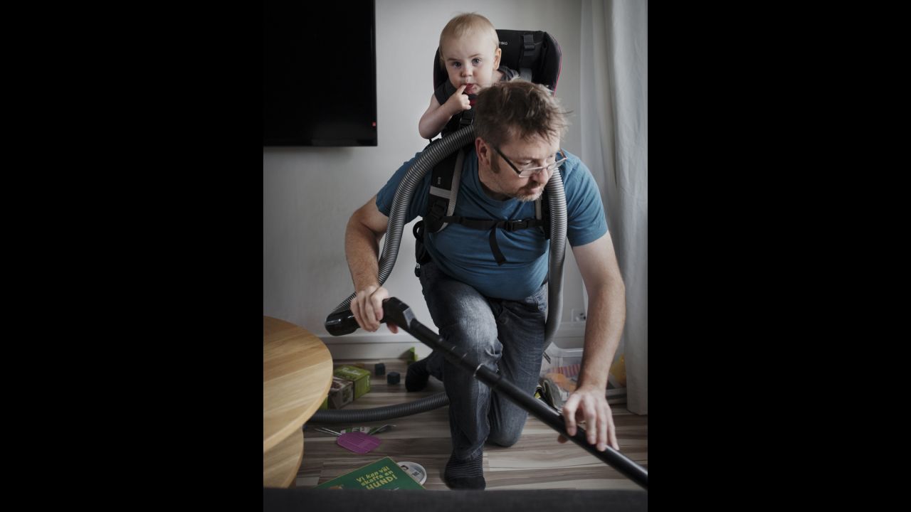 Ola Larsson, 41, works around the house with his son Gustav.