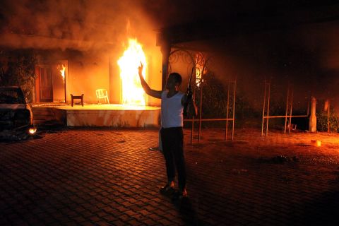 An armed man stands next to buildings set on fire at the U.S. consulate in Benghazi, Libya, on September 11, 2012. U.S. Ambassador J. Christopher Stevens and three other U.S. nationals were killed in the attack.