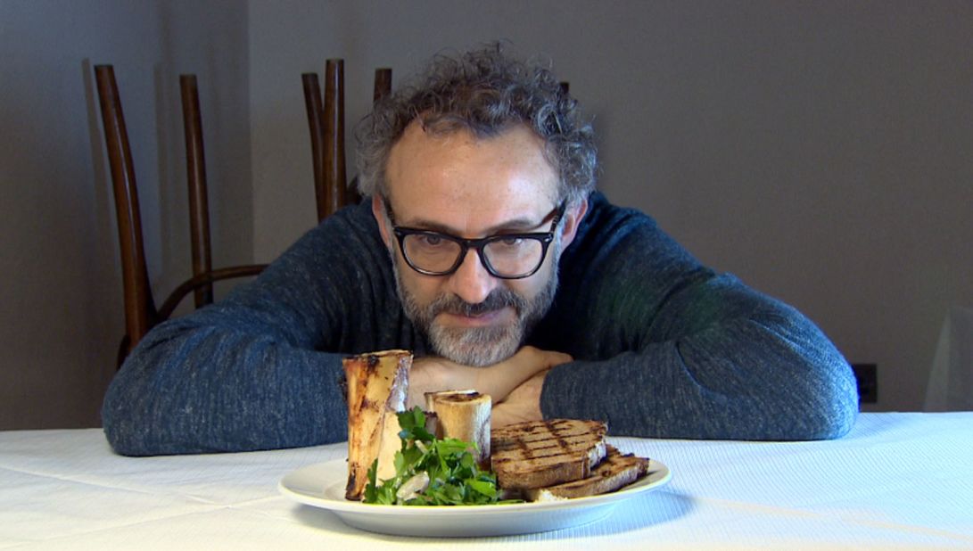 Legendary chef Massimo Bottura contemplates a dish of roasted bone marrow and parsley salad at St. John restaurant. A signature dish, the restaurant goes through 20-30 kilograms of marrow bones daily.