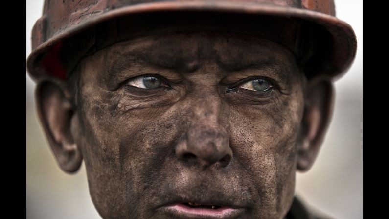 A Ukrainian coal miner waits for a bus after exiting the Zasyadko mine, where he helped search for the bodies of his colleagues Wednesday, March 4, in Donetsk, Ukraine. Thirty-three workers were killed <a href="http://www.cnn.com/2015/03/04/europe/ukraine-miners-trapped/index.html" target="_blank">after an early morning explosion</a> at the mine.