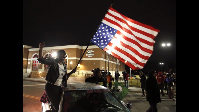 Gina Gowdy joins protesters outside a Ferguson, Missouri, fire station, on Wednesday, March 4. The U.S. Justice Department <a href="http://www.cnn.com/2015/03/04/politics/ferguson-darren-wilson-justice-department-report/index.html" target="_blank">formally closed its investigation</a> of Ferguson police officer Darren Wilson, declining to bring criminal charges for the killing of Michael Brown in August. The Justice Department also issued a 100-page report that it said found systemic racial discrimination by the Ferguson police and court system against African-Americans.