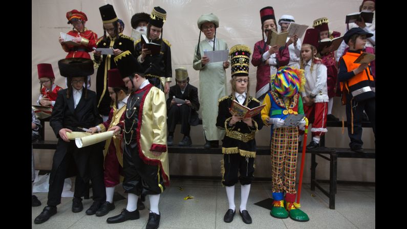 Ultra-Orthodox Jewish boys wearing costumes read the Book of Esther at a synagogue in Bnei Brak, Israel, on Wednesday, March 4.