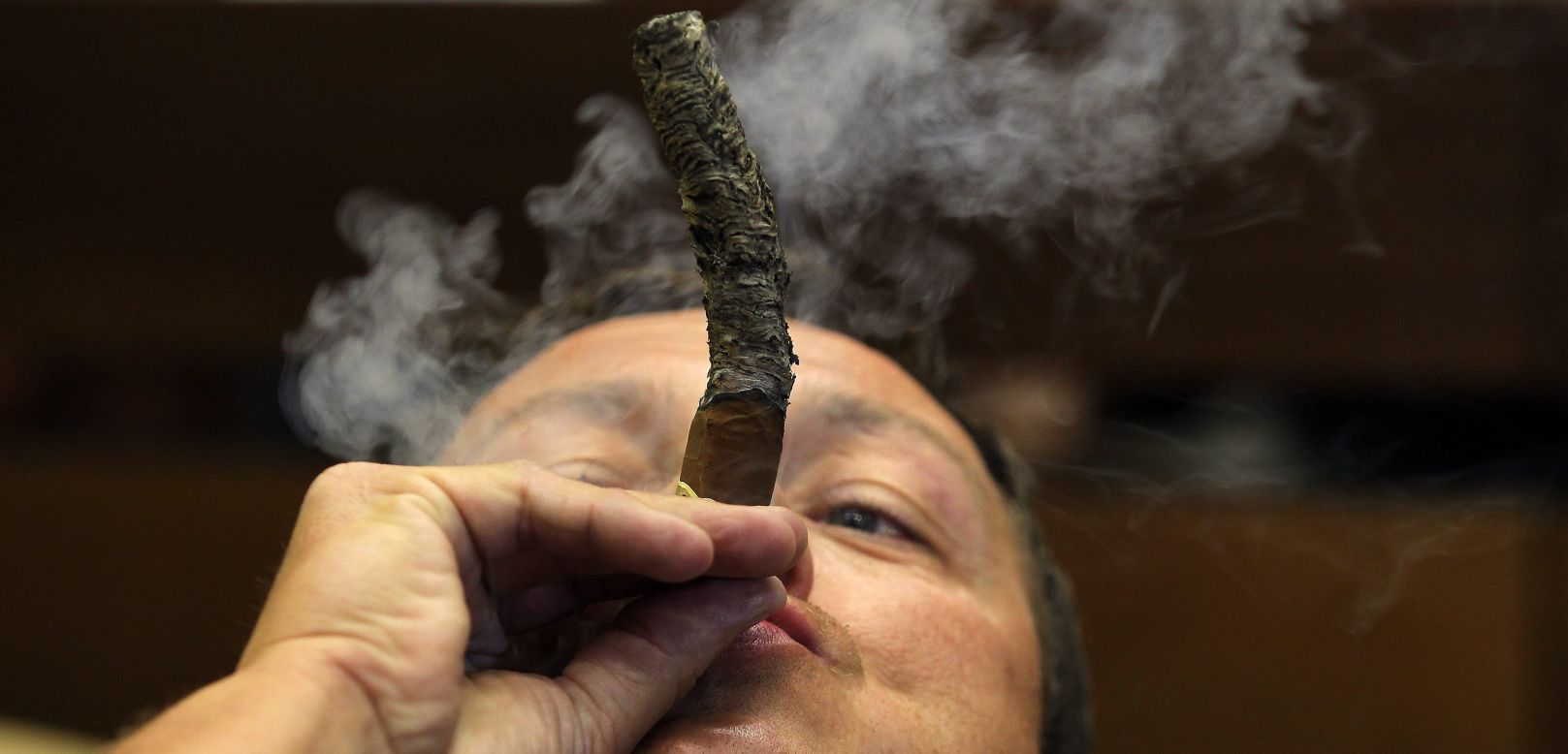 A man participates in a contest to see who can keep the longest cigar ash during the Cigar Festival in Havana, Cuba, on Thursday, February 26.
