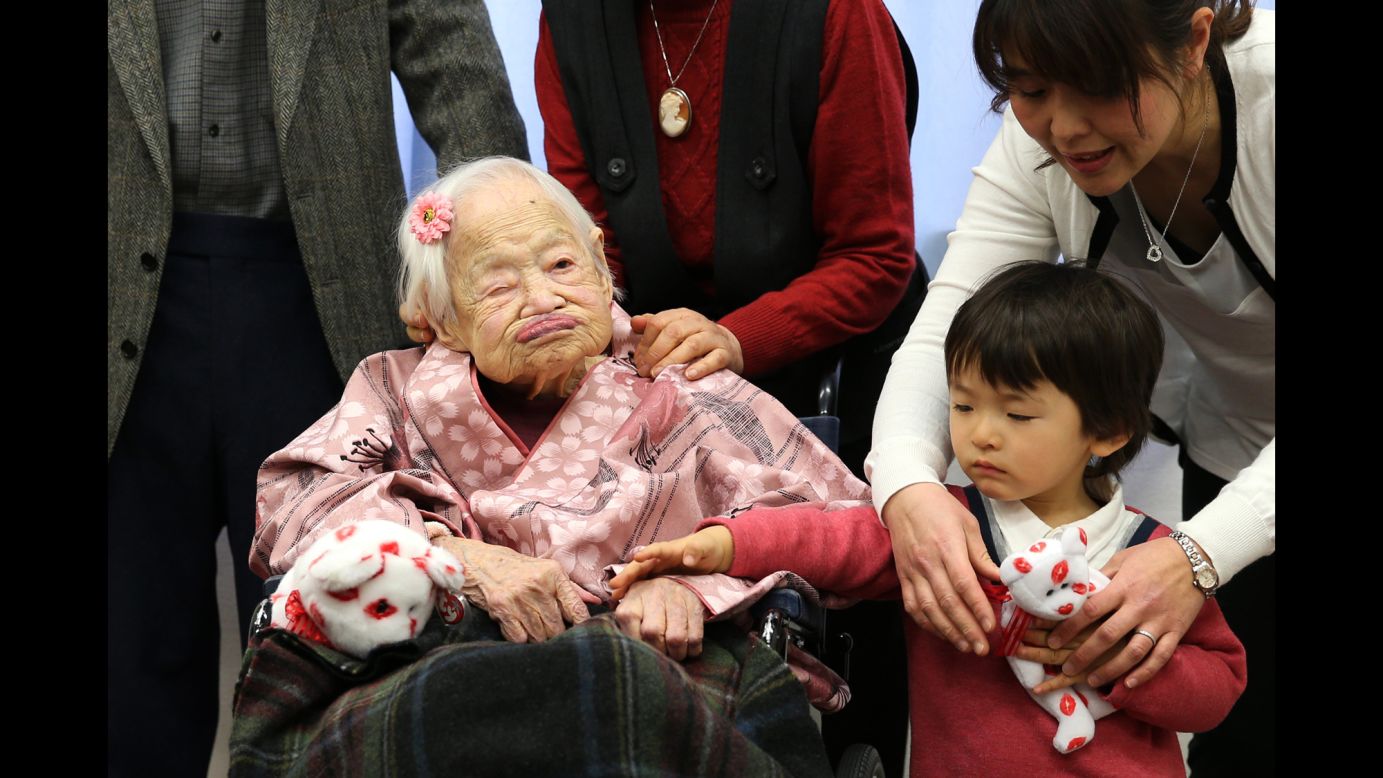 Misao Okawa, the world's oldest person, poses for a photo on her 117th birthday Wednesday, March 4, at a nursing home in Osaka, Japan.