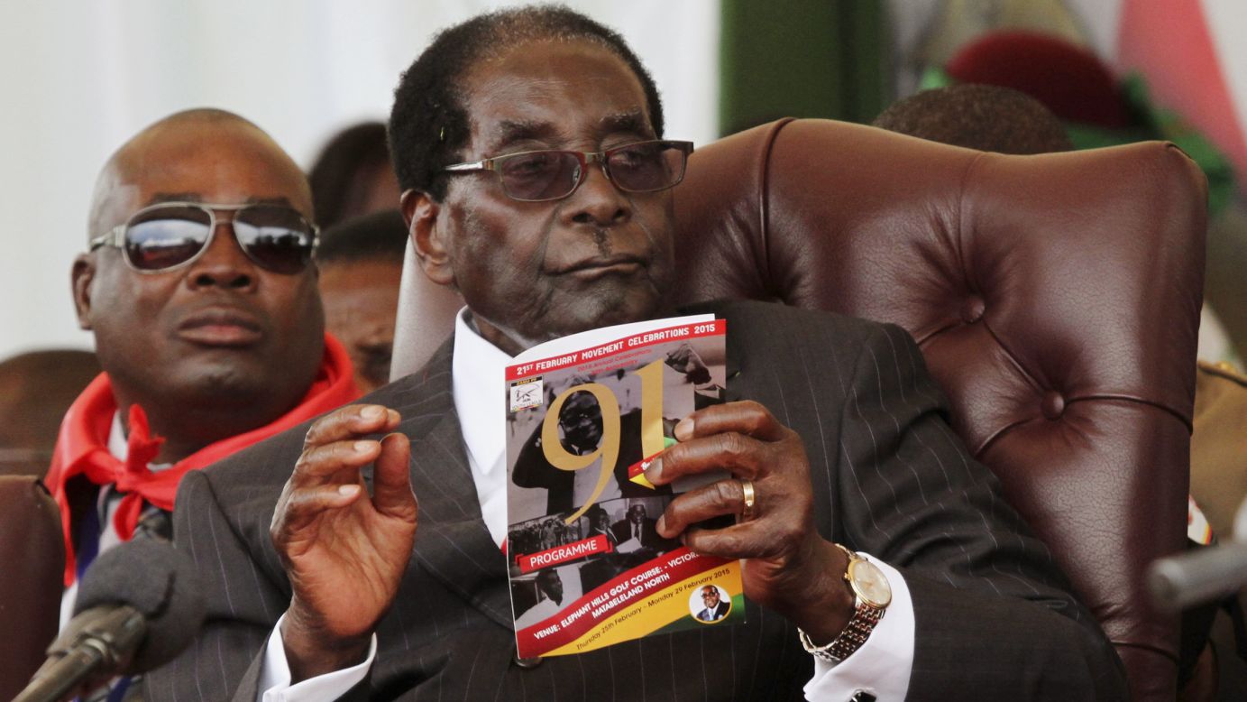Zimbabwean President Robert Mugabe holds a booklet during his 91st birthday celebration Saturday, February 28, in Victoria Falls, Zimbabwe.