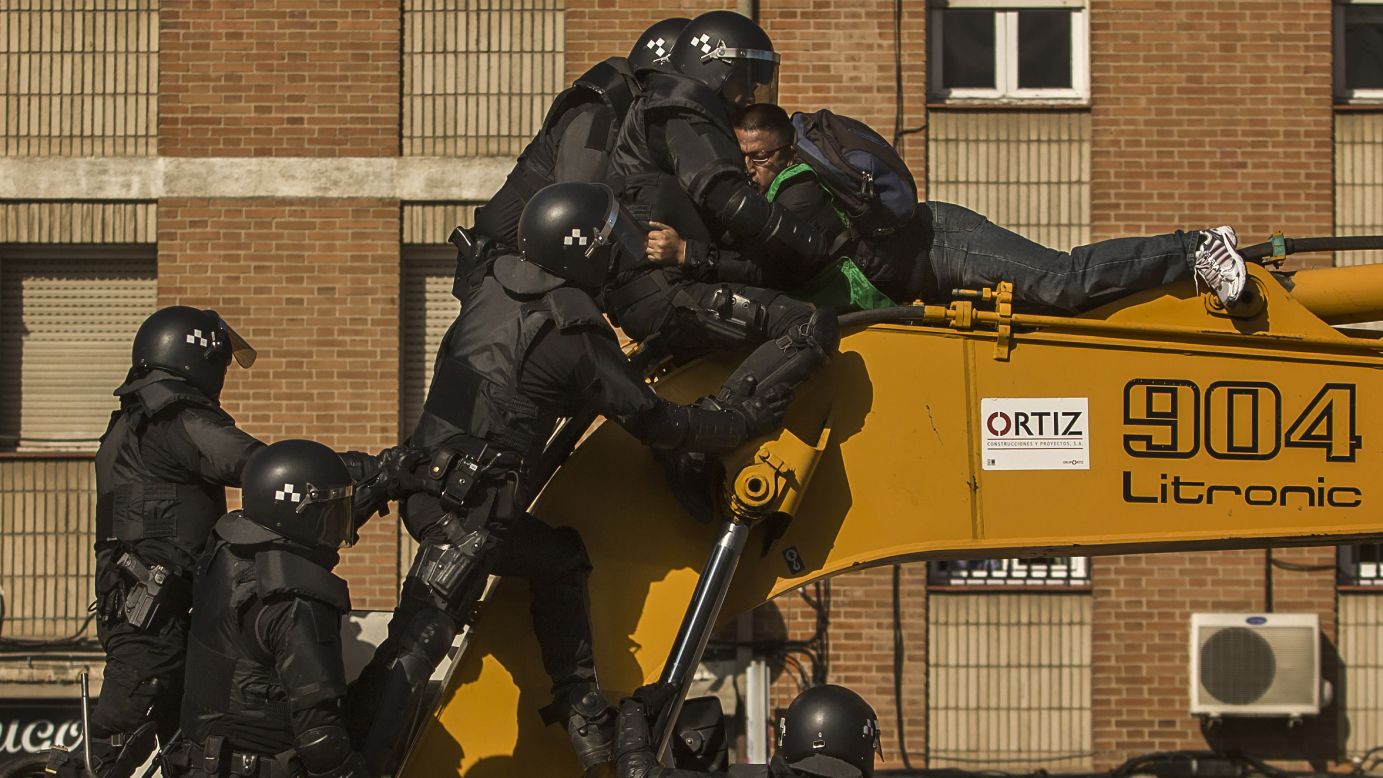 Police in Madrid remove a housing rights activist from a bulldozer as he tries to stop the demolition of a family's house on Friday, February 27. Madrid authorities say 11 people were arrested after several dozen protesters clashed with police who were carrying out an eviction order. Evictions in Spain have soared since the country's economic crisis began in 2008 and increasing numbers of people were unable to meet mortgage payments. Protesters regularly try to prevent evictions, but Friday's clash was particularly tense after a campaign to keep the family in its home.