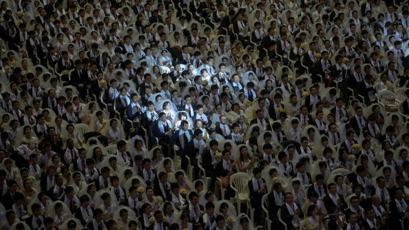 Couples attend a mass wedding held by the Unification Church in Gapyeong, South Korea, on Tuesday, March 3.