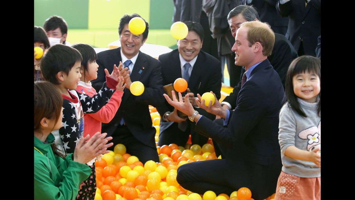 Britain's Prince William plays with children in Koriyama, Japan, on Saturday, February 28. He was in Japan for a four-day visit.
