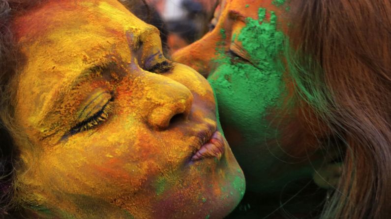 College students in Kolkata, India, hug each other as they play with colored powder for the Holi festival on Monday, March 2.