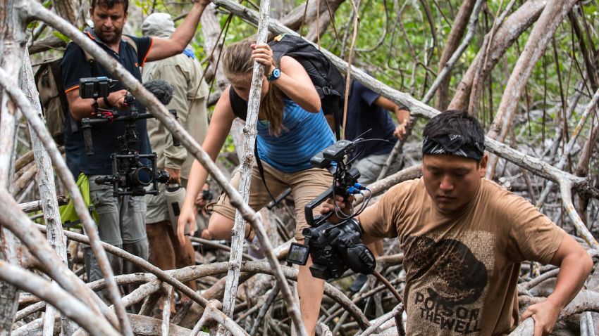 The crew of The Wonder List with Bill Weir navigates a mangrove swamp while filming in the Galapagos.