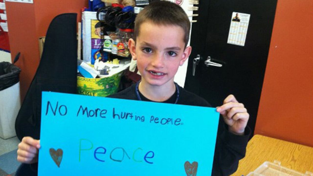 An image taken from Facebook shows Martin Richard, the 8-year-old killed during the explostions at the Boston Marathon, holding a shign calling for peace. 