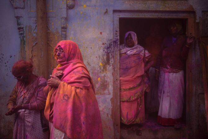 Widows stand covered with colored powder after celebrations March 3 in Vrindavan.