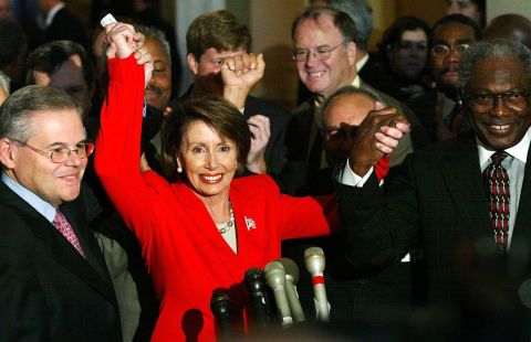 Newly elected House Minority Leader Rep. Nancy Pelosi (D-CA) (second left) joins hands with fellow Democratic Rep. Robert Menendez (D-NJ) (left) and Rep. James Clyburn (D-SC) (right) to celebrate Pelosi's victory to be the new House minority leader for the 108th Congress on November 14, 2002.