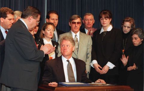 President Bill Clinton (center-seated) looks up after signing a bill into law which is designed to tighten the U.S. embargo on Cuba during ceremonies on March 12, 1996 at the White House in Washington, D.C. 