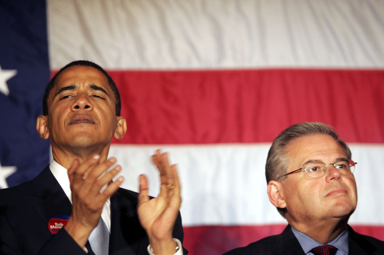 Barack Obama and Robert Menendez listen to New Jersey Governor Jon Corzine at a rally for Menendez October 12, 2006 at the Masonic Temple in Trenton, New Jersey.