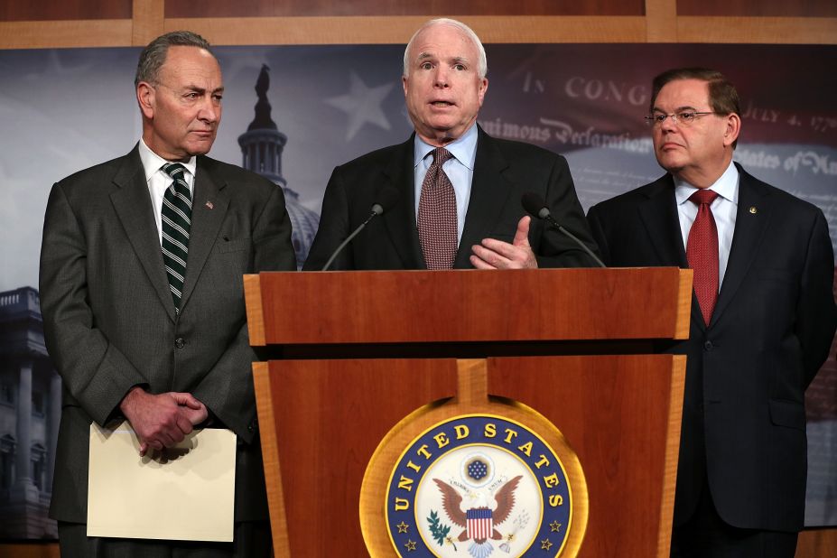 Sen. John McCain (R-AZ) (center) speaks as Sen. Charles Schumer (D-NY) (left) and Sen. Robert Menendez (D-NJ) (right) listen during a news conference on a comprehensive immigration reform framework January 28, 2013 on Capitol Hill in Washington.