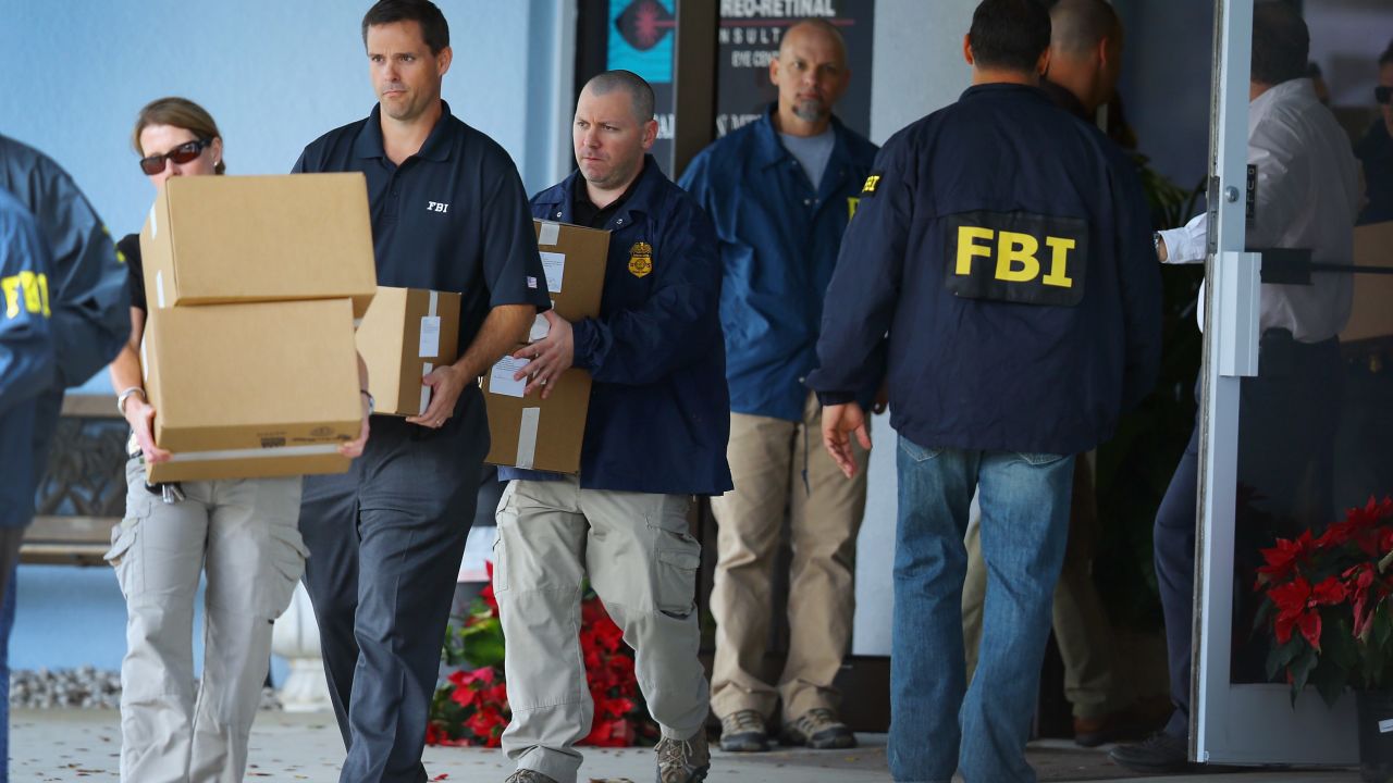 FBI agents carry out boxes as law enforcement officials investigate the medical-office complex of Dr. Salomon Melgen who has possible ties to U.S. Sen. Bob Menendez (D-NJ) on January 30, 2013 in West Palm Beach, Florida. The agents arrived last night at the medical-office complex and started hauling away potential evidence in several vans. 