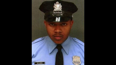 Officer  Robert Wilson III was buying a game for his son when two men held up the store and killed him, police said. 