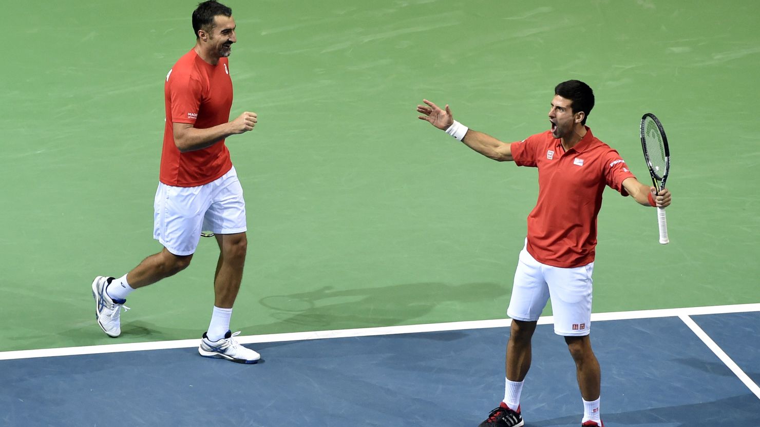 Novak Djokovic (right) and Nenad Zimonjic celebrate after gaining a point against Croatia's Marin Draganja and Franko Skugor during their Davis Cup match.