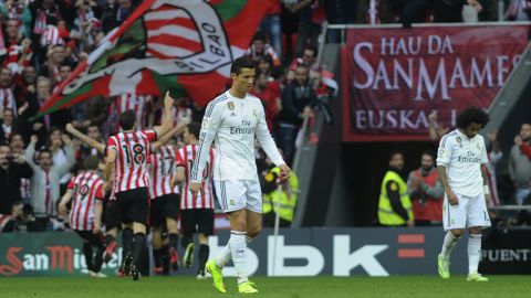 A gloomy Cristiano Ronaldo (center) looks away as Athletic Bilbao players celebrate during its 1-0 victory over Real Madrid.