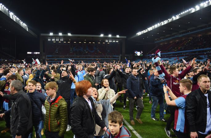Jubilant Aston Villa fans invaded the pitch to celebrate their team's 2-0 English FA Cup quarterfinal victory over local rivals West Bromwich Albion Saturday.