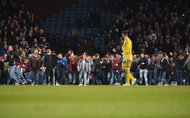 Villa fans flooded on to the pitch before the match was over. Supporters who remained in the stands initially booed those who entered the playing area.