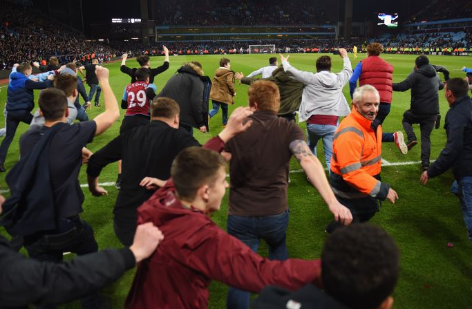 After a brief delay the game was completed, but fans again poured over the hoardings at the sound of the fulltime whistle.