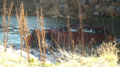 The car was partly submerged in the frigid Spanish Fork River.