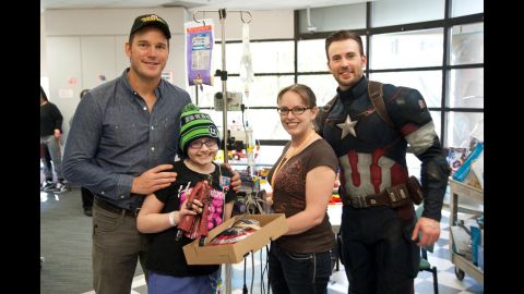 Marvel movie stars Chris Pratt, left, and Chris Evans visit young patients at Seattle Children's Hospital on Saturday as part of a Super Bowl bet in which everyone was a winner.