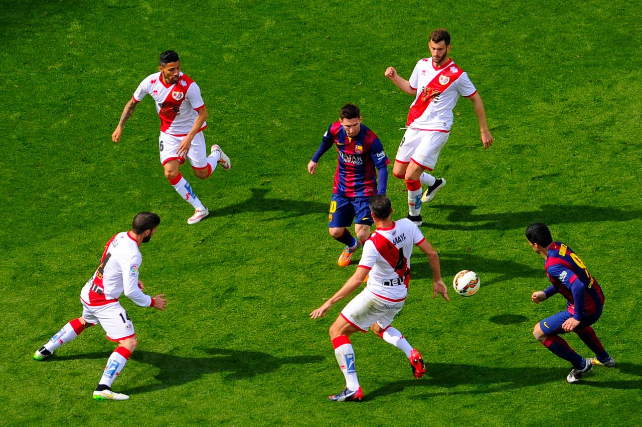 Messi was surrounded by Rayo Vallecano players in this La Liga match, but still managed the 32nd hat-trick of his career as Barca romped to a 6-1 win.