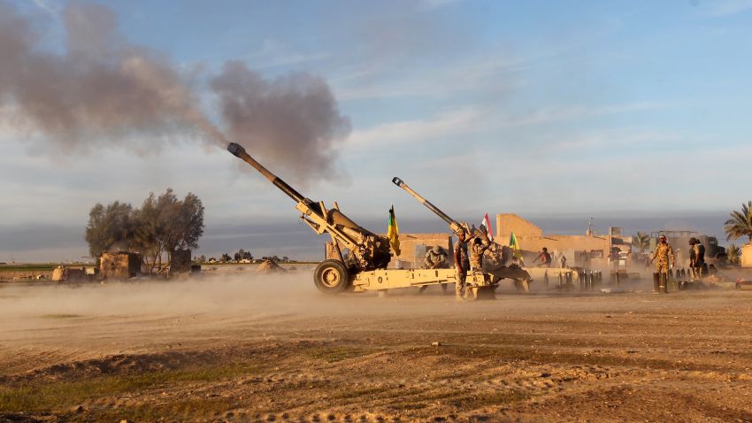 The Shiite fighters fire Howitzer Cannons towards positions on Saturday, March 7 on the outskirts of  Ad-Dawr, Iraq.