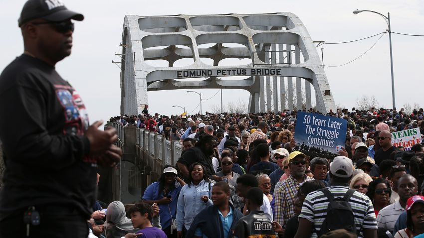 Thousands of people walk across the Edmund Pettus Bridge during the 50th anniversary commemoration of the Selma to Montgomery civil rights march on March 8, 2015 in Selma, Alabama.