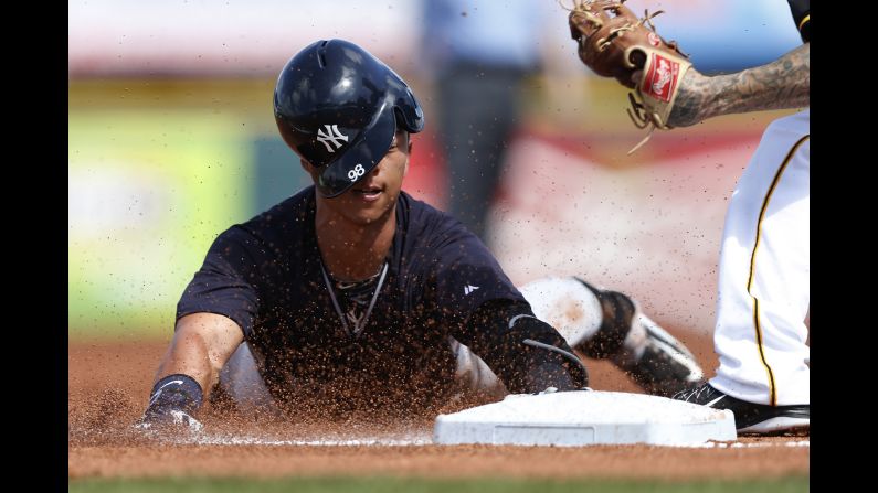 Rob Refsnyder is tagged out at third base while playing for the New York Yankees during a spring-training game Thursday, March 5, in Bradenton, Florida.