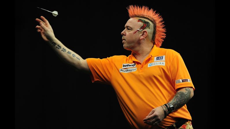 Colorful darts player Peter Wright competes against Michael van Gerwen during a Premier League Darts match Thursday, March 5, in Exeter, England.