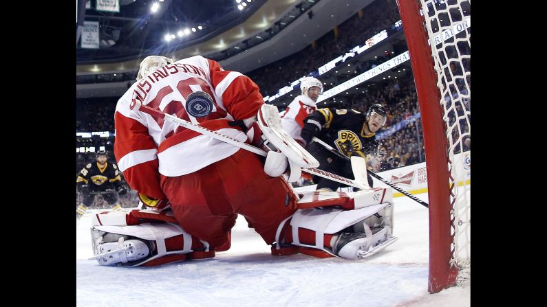 Boston Bruins forward Daniel Paille, right, scores a shorthanded goal past Detroit goaltender Jonas Gustavsson during the Bruins' 5-3 home win on Sunday, March 8.