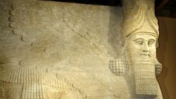 Caption:CHICAGO, IL -SEPTEMBER 29: Standing in front of a colossal human-headed winged bull which once stood at the entrance of the throne room of King Sargon II (721-705 BC) in Khorsabad, capital of Assyria, Donny George, General Director for Research with the Iraq State Board of Antiquities in Baghdad, answers questions during a news conference at the University of Chicago's Oriental Institute September 29, 2003 in Chicago, Illinois. George was at the university to discuss the latest information on lost and endangered artifacts in Iraq. (Photo by Scott Olson/Getty Images)