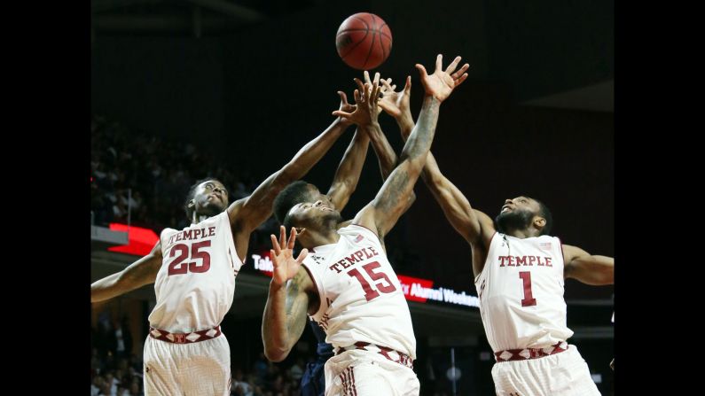 From left, Temple guards Quenton DeCosey, Jaylen Bond and Josh Brown reach for a rebound with Connecticut forward Kentan Facey during a game in Philadelphia on Saturday, March 7. 
