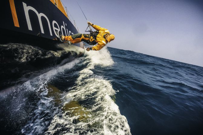 Sailor Dave Swete checks for debris on the keel, after sailing through a current line full of trash and rope, 100 miles south of the Vietnam coast.