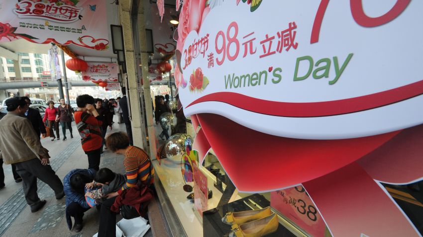 :A sign advertises discounts for International Women's Day in a store in Shanghai on March 8, 2013. International Women's Day in China is celebrated with various events including discount shopping for women at malls in cities around China. AFP PHOTO/Peter PARKS (Photo credit should read PETER PARKS/AFP/Getty Images)