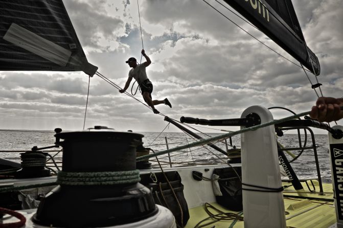 Sailor Gerd-Jan Poortman shows off his acrobatic skills as he makes adjustments to the clew during Leg 3 between the United Arab Emirates and China. 