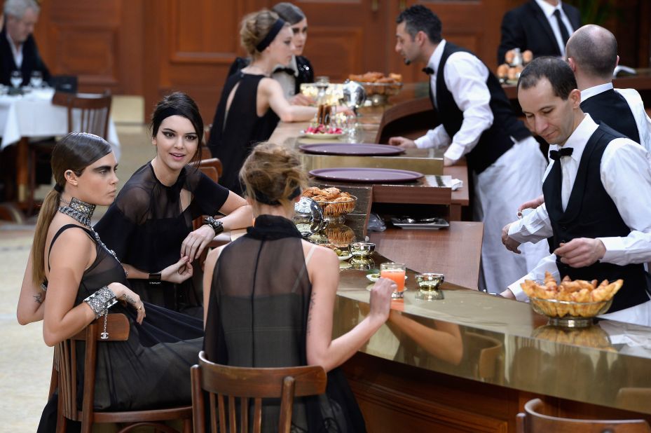 At Chanel, models stopped for a drink at Brasserie Gabrielle, the elaborate set made to look like an elegant Parisian restaurant.
