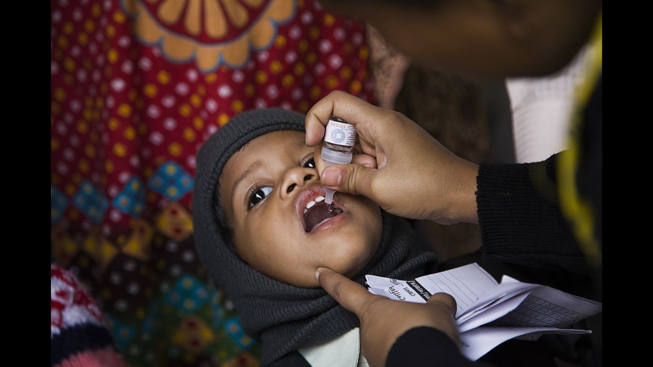 A child is vaccinated at a train station in Kolkata, India, in January 2014. Transit stations have been key points for the Pulse Polio immunization program.
