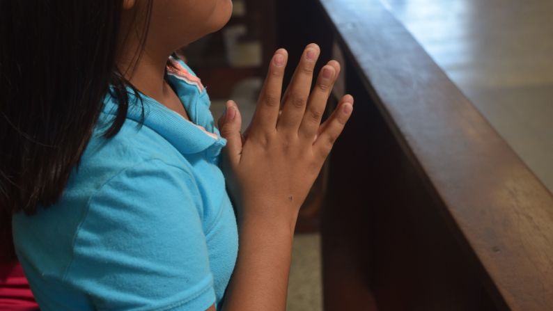 A girl prays at the San Pedro Sula Cathedral.