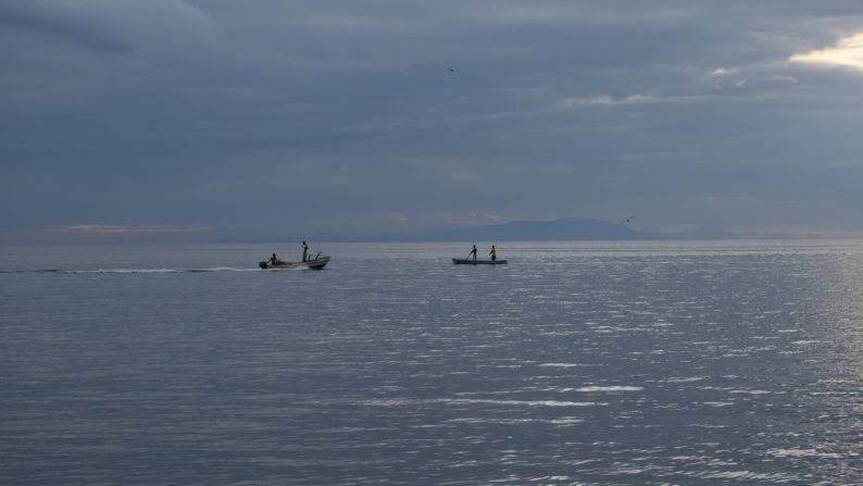 Fishermen go out to sea as night falls in Puerto Cortés, Honduras.