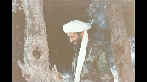Bin Laden laughs during a walk. 