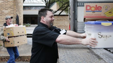 Steve Joule, executive chef at the City Rescue Mission, loads a container of sugar from the kitchen of the SAE house in Norman on March 10. The fraternity is donating its food to the mission after its house was shut down by the university.