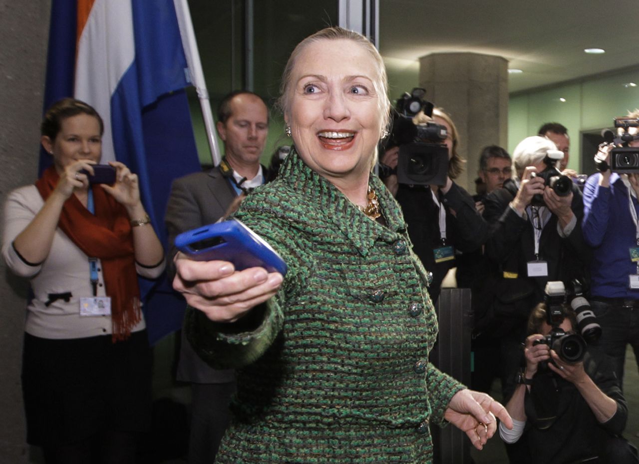 Clinton hands off her phone after arriving to meet with Dutch Foreign Minister Uri Rosenthal in The Hague, Netherlands, in December 2011. 