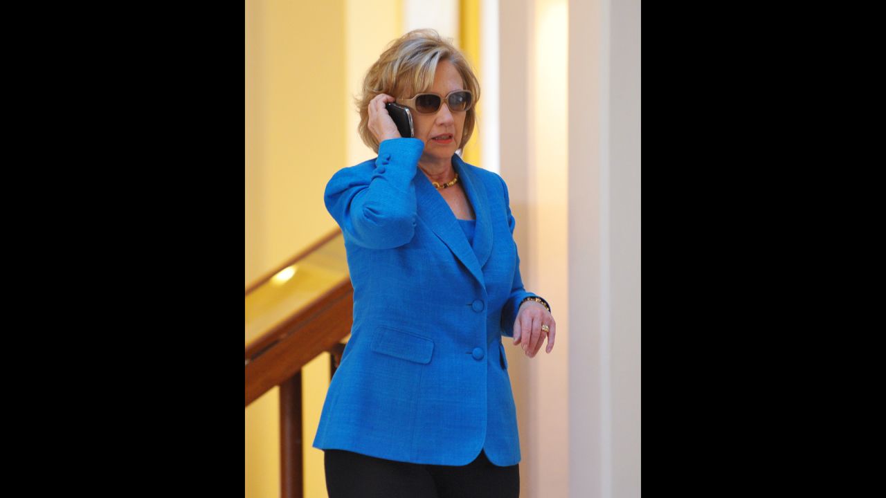 Clinton speaks on a phone in the lobby of a Honolulu hotel before briefing reporters on the Haiti earthquake in January 2010.