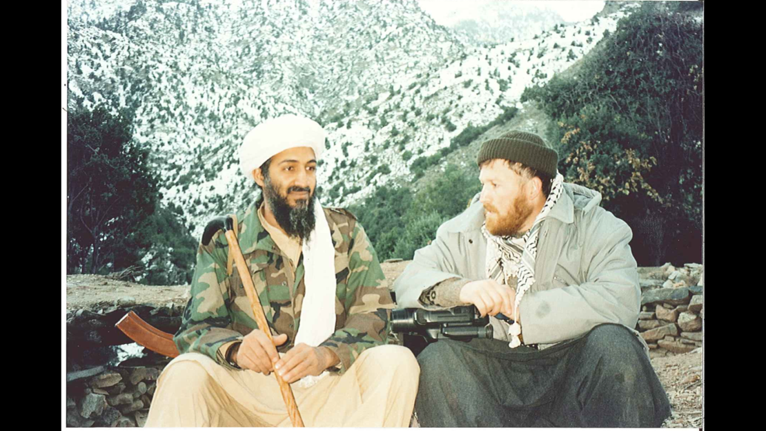 Osama bin Laden, with his Kalashnikov rifle, sits at the base of a Tora Bora mountain with Syrian-born ideologue Abu Musab al-Suri.